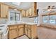 Functional kitchen with wood cabinets and a view to the dining area at 1152 S Sioux Dr, Apache Junction, AZ 85119