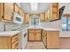 Well-lit kitchen with wood cabinets and white countertops, ready for cooking at 1152 S Sioux Dr, Apache Junction, AZ 85119