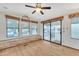 Bright living room with hardwood floors, large windows, and a sliding glass door at 1152 S Sioux Dr, Apache Junction, AZ 85119