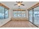 Bright living room featuring hardwood floors, three large windows, and sliding door access at 1152 S Sioux Dr, Apache Junction, AZ 85119