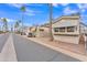 Street view of homes in a quiet neighborhood with palm trees under a clear blue sky at 1152 S Sioux Dr, Apache Junction, AZ 85119