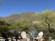 Beautiful backyard featuring manicured landscaping with natural wood adirondack chairs offering views of the surrounding mountains at 11919 N 138Th St, Scottsdale, AZ 85259