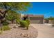 Exterior of home featuring xeriscape landscaping, a two-car garage, and desert plants at 11919 N 138Th St, Scottsdale, AZ 85259