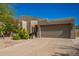 Contemporary home with a two-car garage and desert landscaping at 11919 N 138Th St, Scottsdale, AZ 85259