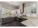 Modern kitchen with stainless steel appliances, white upper cabinets, gray lower cabinets, and marble countertops at 11919 N 138Th St, Scottsdale, AZ 85259