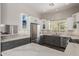 Spacious kitchen featuring stainless steel appliances, marble counters, gray cabinets, and a view to the outside at 11919 N 138Th St, Scottsdale, AZ 85259