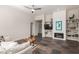 Open-concept living room featuring a fireplace, bookshelves, and a comfortable sofa on top of a tile floor at 11919 N 138Th St, Scottsdale, AZ 85259