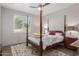 Main bedroom with four-poster bed and shuttered window at 11919 N 138Th St, Scottsdale, AZ 85259