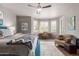 Airy main bedroom with a blue bed, a desk area, natural light, and hardwood floors and a patterned area rug at 11919 N 138Th St, Scottsdale, AZ 85259