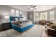 Spacious main bedroom with a blue bed, a desk and a chair, and large windows with plantation shutters at 11919 N 138Th St, Scottsdale, AZ 85259