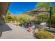 Inviting outdoor patio area featuring comfortable seating, a stylish rug, and a large umbrella for shade and desert mountain views at 11919 N 138Th St, Scottsdale, AZ 85259