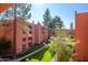 Inviting building exterior featuring lush landscaping, serene walkways, and mature trees under a clear blue sky at 12222 N Paradise Village S Pkwy # 337, Phoenix, AZ 85032