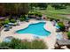 Aerial view of a large community pool with plenty of seating and shade, surrounded by green spaces and landscaping at 12222 N Paradise Village S Pkwy # 337, Phoenix, AZ 85032