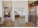 Spacious main bathroom featuring a glass door shower and soaking tub with arched windows at 12926 W Pershing St, El Mirage, AZ 85335