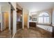 Elegant bathroom with a glass door shower, soaking tub, and decorative tile flooring at 12926 W Pershing St, El Mirage, AZ 85335