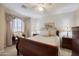 Bedroom with a sleigh bed, side tables, and window with valance at 12926 W Pershing St, El Mirage, AZ 85335