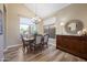 Elegant dining room with chandelier and views to backyard at 12926 W Pershing St, El Mirage, AZ 85335