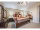 Bedroom with a decorative queen bed, dresser, and mirrored closet at 12926 W Pershing St, El Mirage, AZ 85335