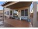 Relaxing covered patio features a charming bench and ample space for enjoying the outdoors at 12926 W Pershing St, El Mirage, AZ 85335