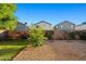 Spacious gravel backyard featuring mature landscaping and privacy fencing at 12947 W Mauna Loa Ln, El Mirage, AZ 85335