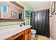 Cozy bathroom with tile floors, vanity sink, and framed mirror at 12947 W Mauna Loa Ln, El Mirage, AZ 85335