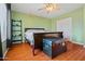 A cozy bedroom with wood flooring, a ceiling fan, and a double-door closet at 12947 W Mauna Loa Ln, El Mirage, AZ 85335