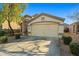 Charming single-story home featuring a two-car garage, desert landscaping, and neutral color palette at 12947 W Mauna Loa Ln, El Mirage, AZ 85335