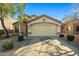 Inviting home with a two-car garage, well-maintained landscaping, and a warm, welcoming facade at 12947 W Mauna Loa Ln, El Mirage, AZ 85335