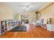 Bright living room with wood floors, ceiling fan, a sliding glass door to the patio, and ample storage space at 12947 W Mauna Loa Ln, El Mirage, AZ 85335