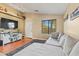 Bright living room featuring a sectional sofa and a large window for ample natural light at 12947 W Mauna Loa Ln, El Mirage, AZ 85335