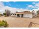 Spacious desert-landscaped backyard featuring a covered patio with outdoor space at 13110 W Blue Bonnet Dr, Sun City West, AZ 85375