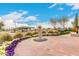 Park area featuring beautiful landscaping, a water feature, and shade structures at 13110 W Blue Bonnet Dr, Sun City West, AZ 85375