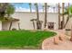 View of the community center clubhouse surrounded by lush landscaping at 13110 W Blue Bonnet Dr, Sun City West, AZ 85375