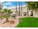 Community clubhouse showcasing desert landscaping, palm trees and green lawn at 13110 W Blue Bonnet Dr, Sun City West, AZ 85375