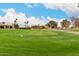 Scenic view of the golf course featuring well-manicured greens and mature trees at 13110 W Blue Bonnet Dr, Sun City West, AZ 85375