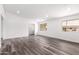 Spacious room with wood-look vinyl flooring and natural light, offering versatility for various uses at 13110 W Blue Bonnet Dr, Sun City West, AZ 85375