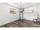 Versatile utility room with modern wood-look flooring, water heater and utility sink at 13110 W Blue Bonnet Dr, Sun City West, AZ 85375