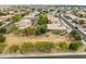 A distant high angle shot of a home in a neighborhood with desert landscaping at 15146 W Highland Ave, Goodyear, AZ 85395