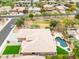 An aerial view of a home showing the roof, backyard, and pool at 15146 W Highland Ave, Goodyear, AZ 85395