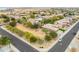 An aerial view of a house in a desert landscaped neighborhood at 15146 W Highland Ave, Goodyear, AZ 85395