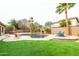 Inviting backyard featuring a sparkling pool, tropical landscaping, and a seating area at 15146 W Highland Ave, Goodyear, AZ 85395