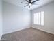 Bedroom with neutral walls, carpet flooring, ceiling fan, and window shutters at 15146 W Highland Ave, Goodyear, AZ 85395