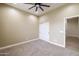 Bedroom with neutral walls, carpet flooring, ceiling fan, and a closet at 15146 W Highland Ave, Goodyear, AZ 85395