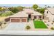 The front exterior of a single Gathering home featuring a paver driveway and a two-car garage at 15146 W Highland Ave, Goodyear, AZ 85395