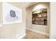 Inviting hallway with arched niche shelving, decorative accents, and stylish artwork at 15146 W Highland Ave, Goodyear, AZ 85395