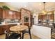 Gourmet kitchen featuring custom cabinets, granite countertops, and a stylish brick arch over the cooktop at 15146 W Highland Ave, Goodyear, AZ 85395