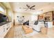 Open concept living room with modern furniture, stone accent wall, and seamless flow to the kitchen at 15146 W Highland Ave, Goodyear, AZ 85395