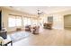 Bright living room featuring neutral decor, large windows, laminate floors and bar seating at 15146 W Highland Ave, Goodyear, AZ 85395