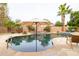 Relaxing backyard pool with mature landscaping, stone accents, and a seating area at 15146 W Highland Ave, Goodyear, AZ 85395