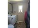 Cozy bathroom with white vanity, framed mirror, patterned shower curtain and decor at 15625 N 25Th St # 21, Phoenix, AZ 85032